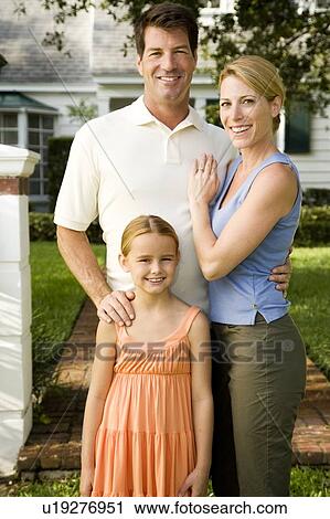 Family standing on the garden path outside their new home View Large Photo Image Stock Image - Family standing on the garden path outside their new home. Fotosearch