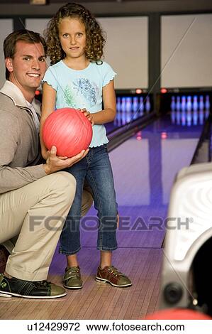 Father and daughter in a bowling alley View Large Photo Image Stock Image - Father and daughter in a bowling alley. Fotosearch