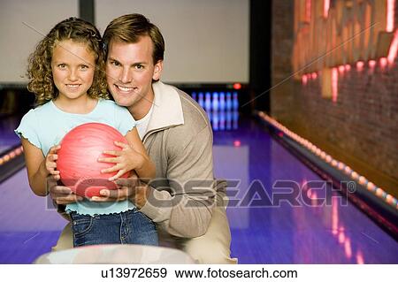 Father and daughter in a bowling alley View Large Photo Image Stock Photo - Father and daughter in a bowling alley. Fotosearch