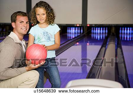 Father and daughter in a bowling alley View Large Photo Image Stock Photo - Father and daughter in a bowling alley. Fotosearch