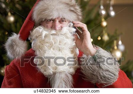Stock Photography - Father christmas / santa Claus talking on a mobile phone. Fotosearch