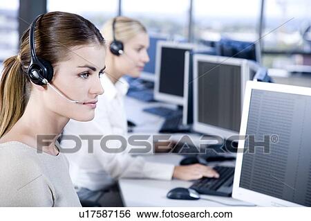 Stock Photograph - Female businesswomen in a call centre. Fotosearch