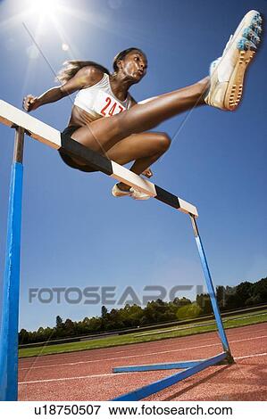Stock Photo - Female hurdler in action. Fotosearch