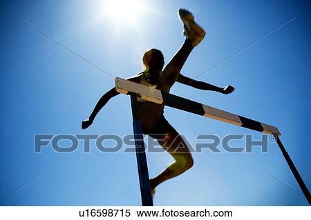 Stock Photography - Female hurdler in action. Fotosearch