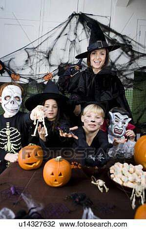 Four friends and a mother at a Halloween party View Large Photo Image Stock Image - Four friends and a mother at a Halloween party . Fotosearch