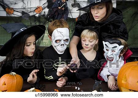 Four friends and a mother at a Halloween party View Large Photo Image Stock Photograph - Four friends and a mother at a Halloween party . Fotosearch