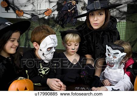 Four friends and a mother at a Halloween party View Large Photo Image Stock Photography - Four friends and a mother at a Halloween party . Fotosearch