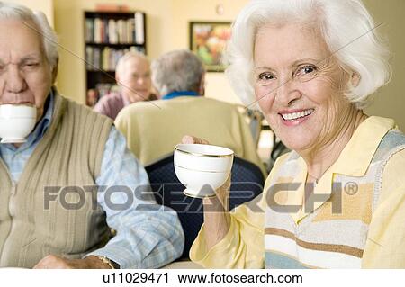 Stock Image - Four residents in a retirement home. Fotosearch