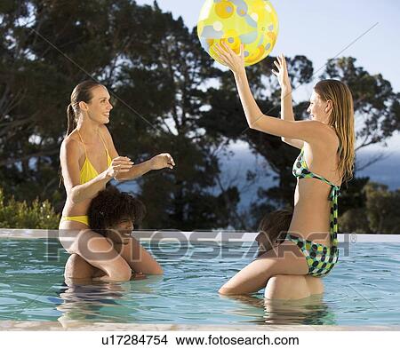 Four teenage friends having fun in a swimming pool View Large Photo Image Picture - Four teenage friends having fun in a swimming pool. Fotosearch