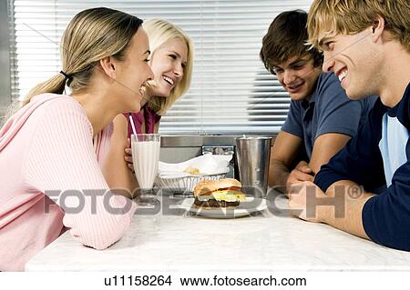 Friends hanging out in a diner View Large Photo Image Picture - Friends hanging out in a diner . Fotosearch