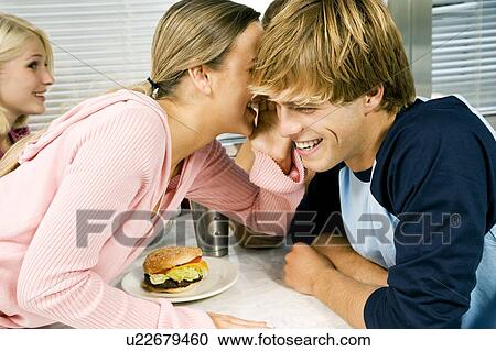 Stock Image - Friends hanging out in a diner . Fotosearch