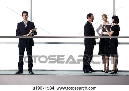 Picture - Group of business colleagues in modern office building. Fotosearch