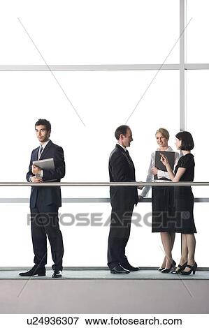Group of business colleagues in modern office building View Large Photo Image Stock Photo - Group of business colleagues in modern office building. Fotosearch