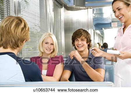 Picture - Group of friends ordering food in a diner . Fotosearch