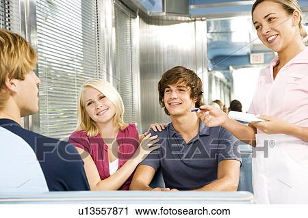 Group of friends ordering food in a diner View Large Photo Image Stock Image - Group of friends ordering food in a diner . Fotosearch