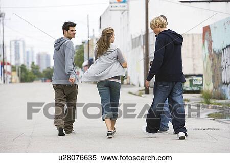 Group of teenagers running down an urban street View Large Photo Image Stock Photography - Group of teenagers running down an urban street . Fotosearch