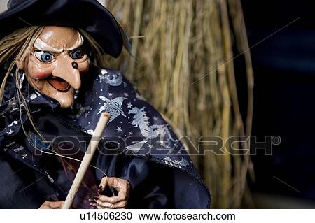 Stock Image - Hallowe'en decorations - puppet witch with wand. Fotosearch