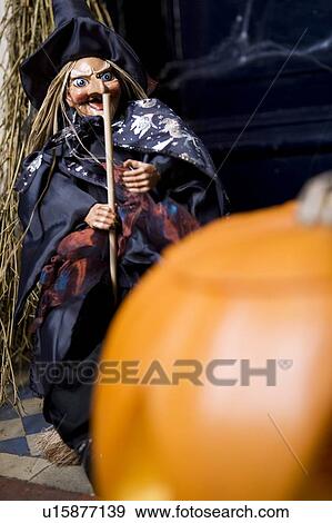 Hallowe'en decorations - puppet witch with wand and orange pumpkin View Large Photo Image Stock Photo - Hallowe'en decorations - puppet witch with wand and orange pumpkin. Fotosearch