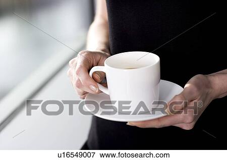 Hands holding a cup of coffee or tea View Large Photo Image Stock Photo - Hands holding a cup of coffee or tea. Fotosearch