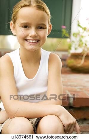 Happy little girl sitting on the front step of her new home View Large Photo Image Stock Image - Happy little girl sitting on the front step of her new home. Fotosearch