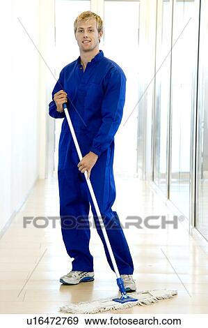 Janitor or cleaning man sweeping the floor of a modern office View Large Photo Image Stock Photo - Janitor or cleaning man sweeping the floor of a modern office. Fotosearch
