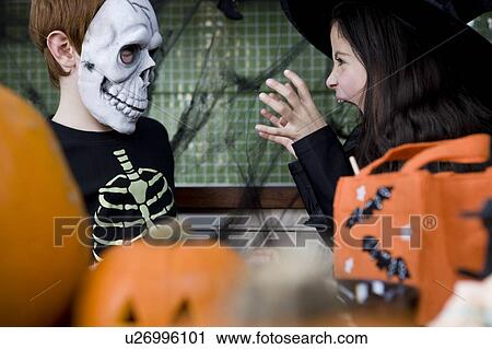 Little boy and girl at a Halloween party View Large Photo Image Stock Image - Little boy and girl at a Halloween party . Fotosearch
