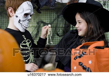 Stock Photo - Little boy and girl at a Halloween party . Fotosearch