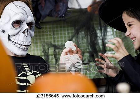 Stock Photography - Little boy and girl at a Halloween party . Fotosearch