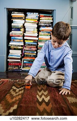 little boy playing with toy car on the floor View Large Photo Image Stock Photo - little boy playing with toy car on the floor. Fotosearch