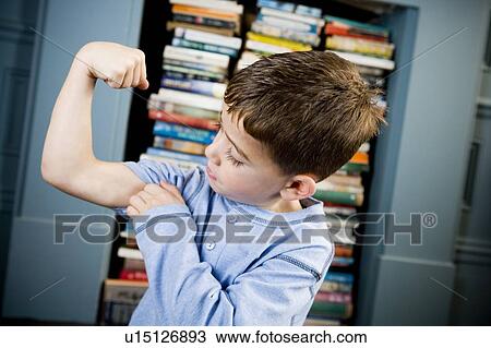Stock Image - little boy showing off his muscles. Fotosearch
