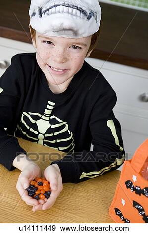 Stock Photo - Little boy with trick or treat sweets. Fotosearch