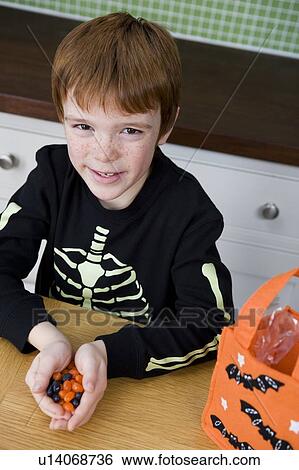 Little boy with trick or treat sweets View Large Photo Image Stock Photograph - Little boy with trick or treat sweets. Fotosearch