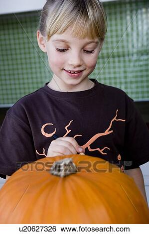 little girl carving a face in a Hallowe'en pumpkin View Large Photo Image Stock Photograph - little girl carving a face in a Hallowe'en pumpkin. Fotosearch