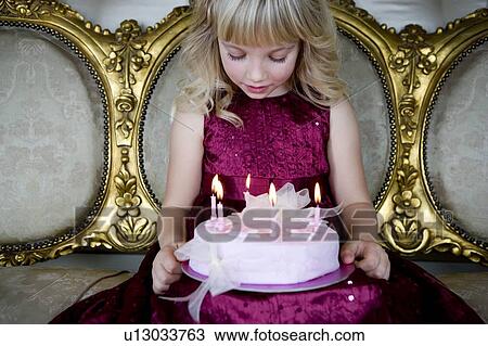 Little girl holding a birthday cake with lit candles View Large Photo Image Stock Image - Little girl holding a birthday cake with lit candles. Fotosearch