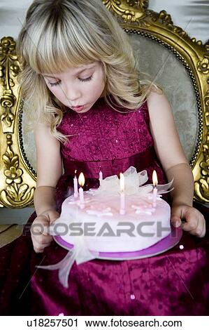 Little girl holding a birthday cake with lit candles View Large Photo Image Stock Image - Little girl holding a birthday cake with lit candles. Fotosearch