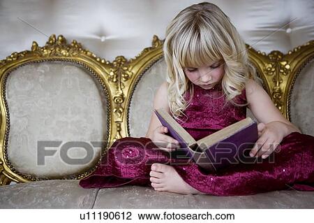 Little girl in a party dress, reading a book View Large Photo Image Stock Image - Little girl in a party dress, reading a book. Fotosearch