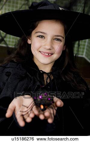 Stock Photograph - Little girl in a witch's costume for Halloween . Fotosearch