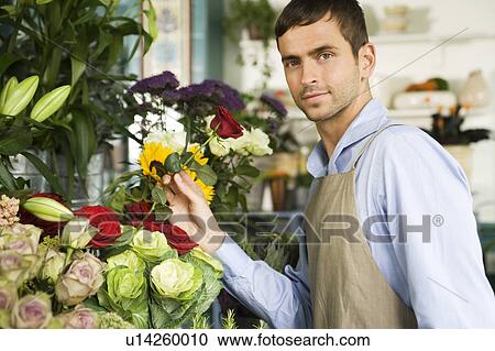 Male florist amongst the flowers in his shop View Large Photo Image Stock Image - Male florist amongst the flowers in his shop. Fotosearch