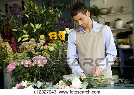 Male florist creating a bouquet of flowers View Large Photo Image Stock Image - Male florist creating a bouquet of flowers. Fotosearch