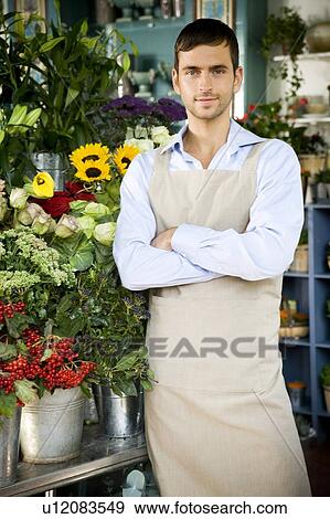 Male florist standing amongst the flowers in his shop View Large Photo Image Stock Photo - Male florist standing amongst the flowers in his shop. Fotosearch