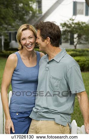 man and woman standing together at garden gate View Large Photo Image Stock Image - man and woman standing together at garden gate. Fotosearch