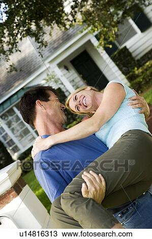 Man carrying his wife across the threshold of their new home View Large Photo Image Stock Image - Man carrying his wife across the threshold of their new home. Fotosearch