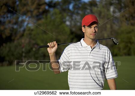 Stock Image - Man playing golf. Fotosearch