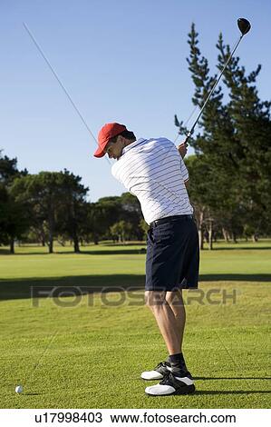 Stock Image - Man playing golf. Fotosearch