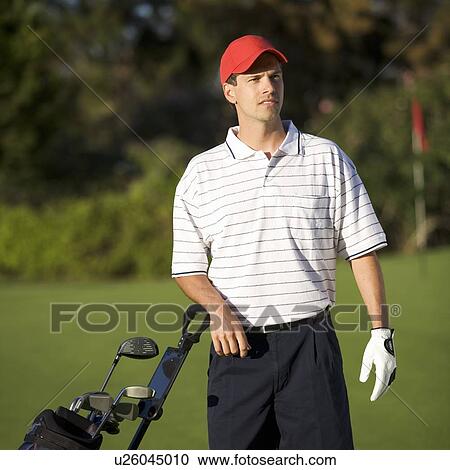 Stock Image - Man playing golf. Fotosearch