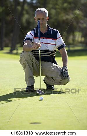 Stock Photo - Man playing golf. Fotosearch