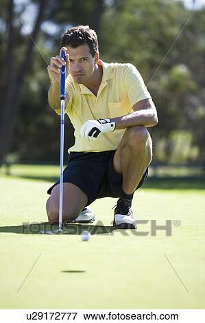 Stock Photo - Man playing golf. Fotosearch