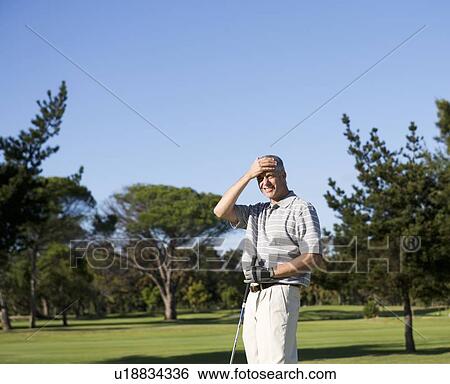 Stock Photograph - Man playing golf. Fotosearch