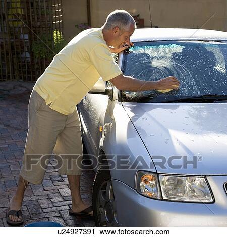 Stock Image - Man washing a car. Fotosearch