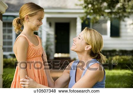 Mother and daughter outside their new home View Large Photo Image Stock Photo - Mother and daughter outside their new home. Fotosearch